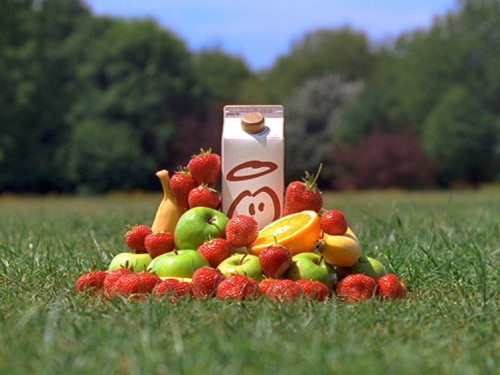 innocent advert with smoothie carton with fruit in park